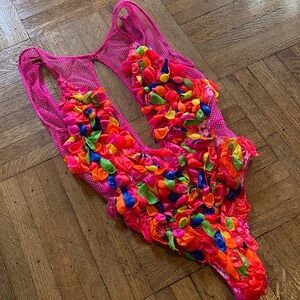 Neon pink bodysuit by Victoria Secret covered in uv reactive water balloons